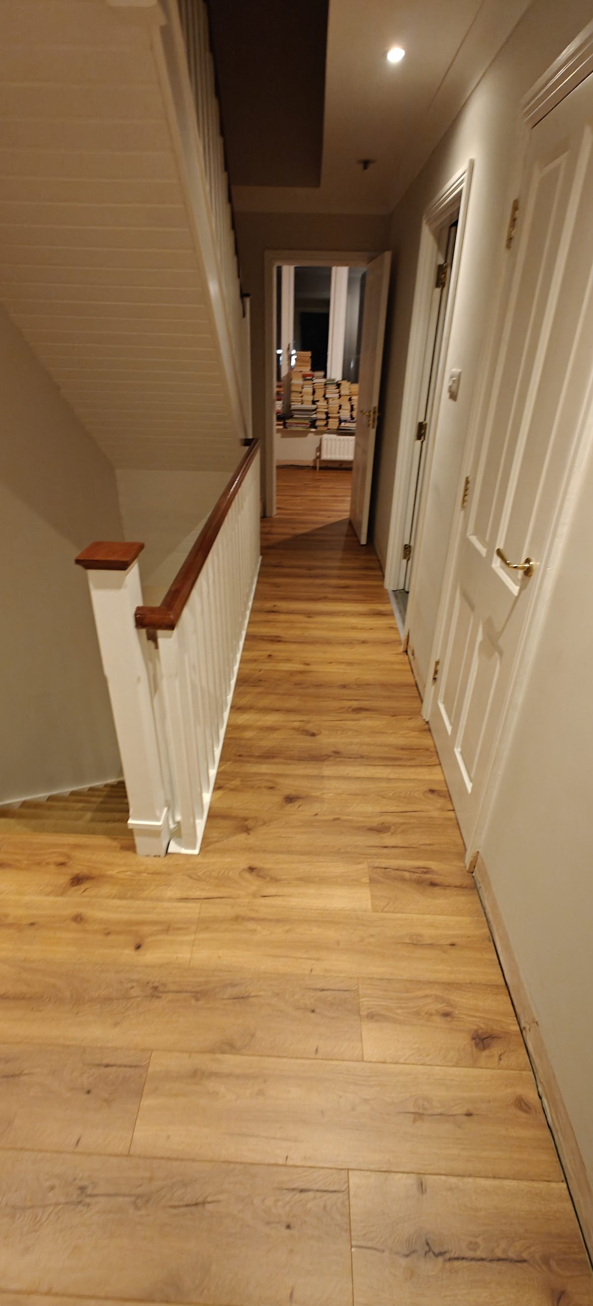 Oak flooring in a hallway with white panelled doors