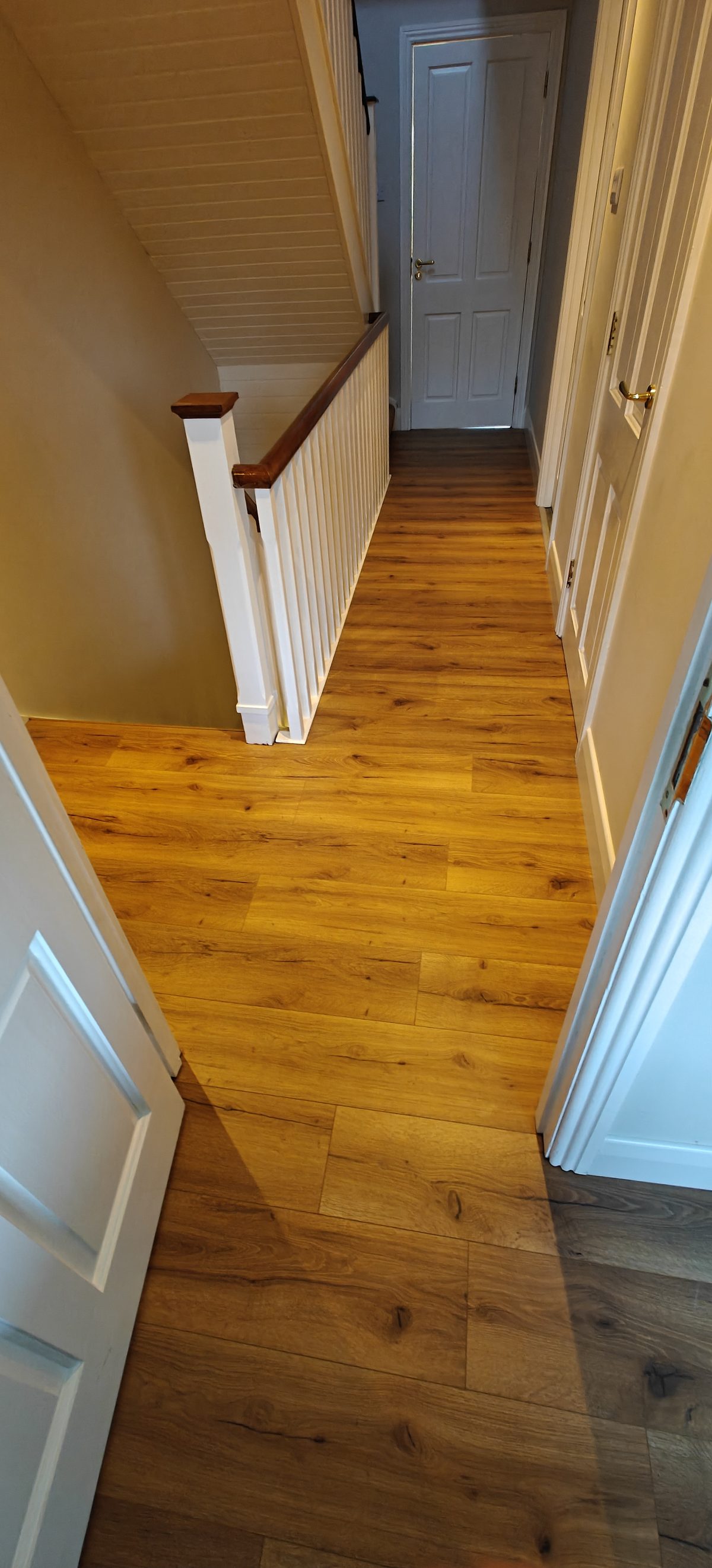 Oak flooring laid through a hallway and up the stairs