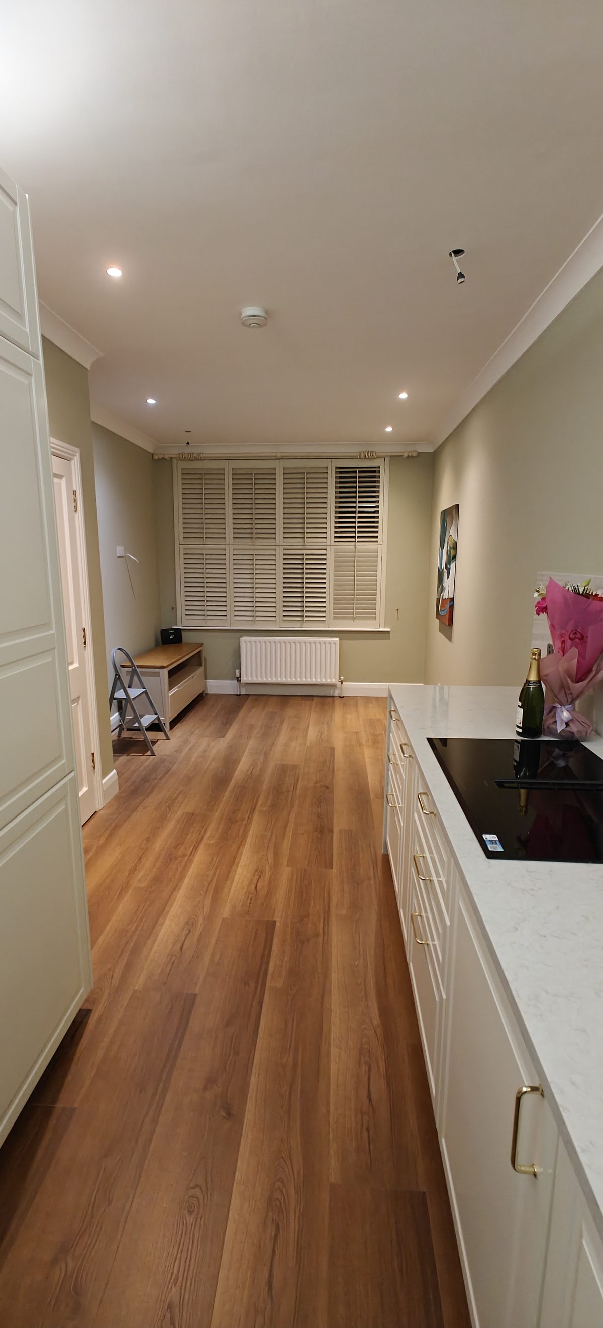 Fitted cream kitchen with oak flooring